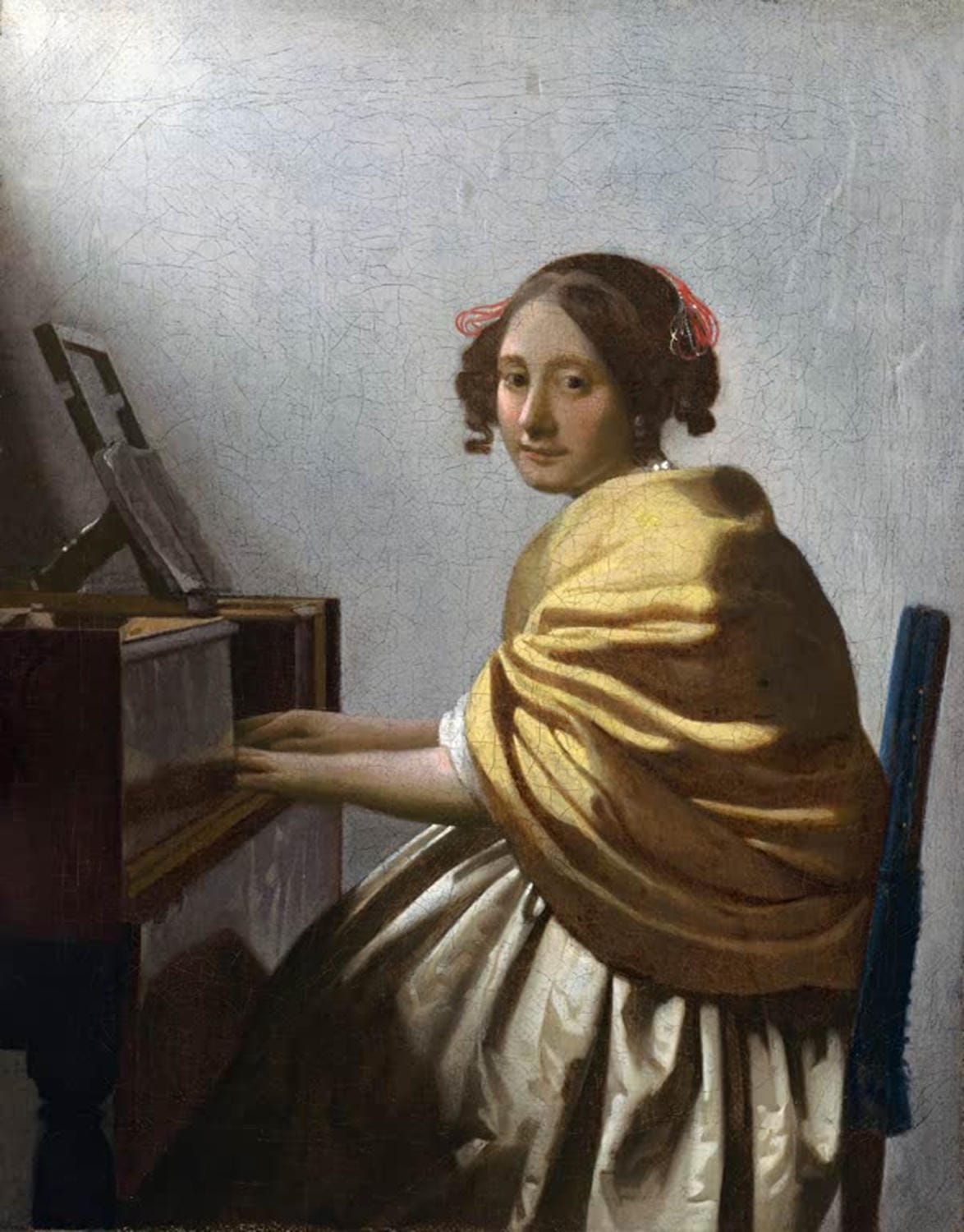 "Eine junge Frau sitzt bei den Virginals" von Johannes Vermeer – Frau am Tasteninstrument im sanften Licht.