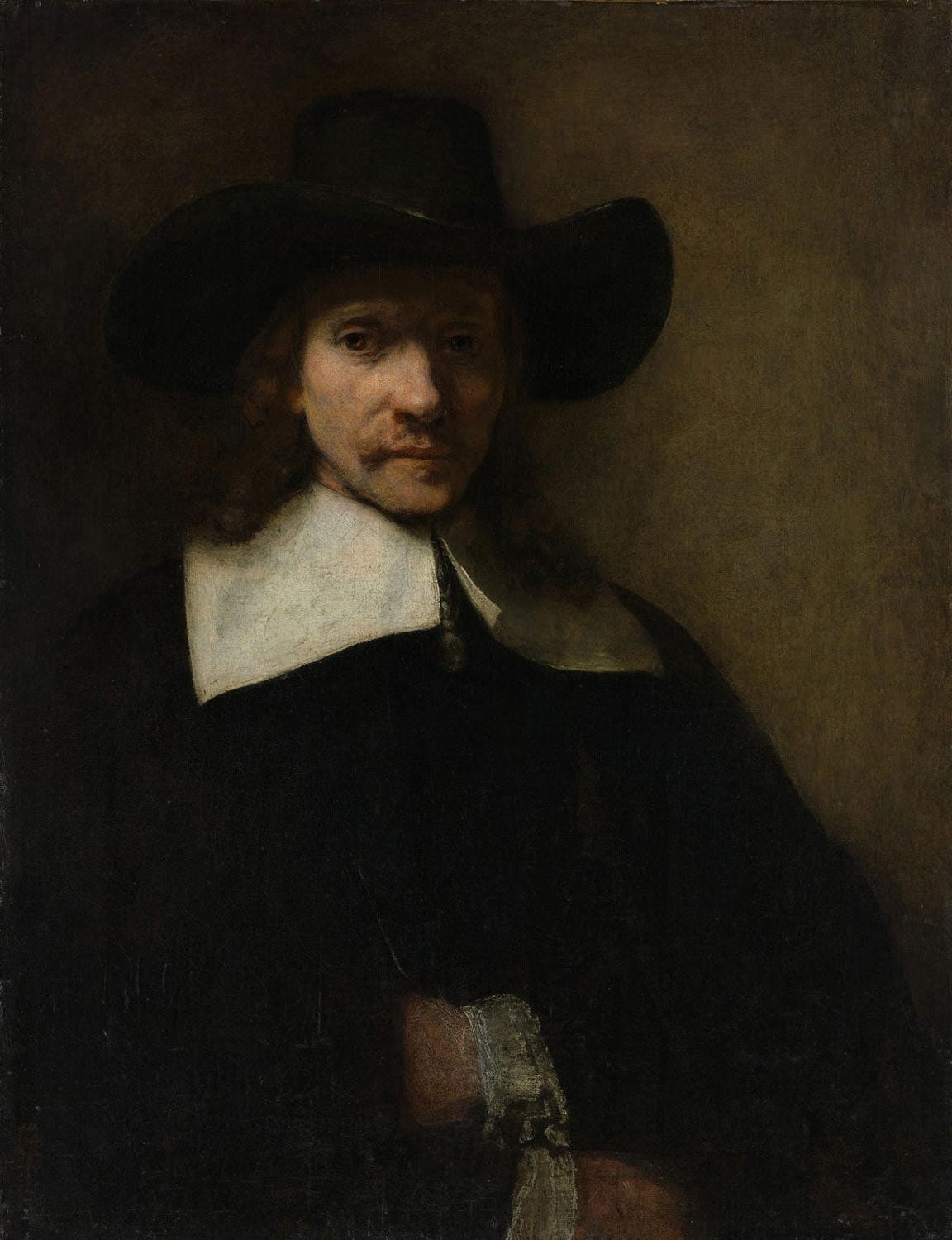 Porträt eines Mannes, gemalt von Rembrandt van Rijn, zeigt einen Mann mit intensiven Gesichtszügen und feiner Kleidung, umgeben von warmen Brauntönen und dramatischem Licht-Schatten-Spiel.
