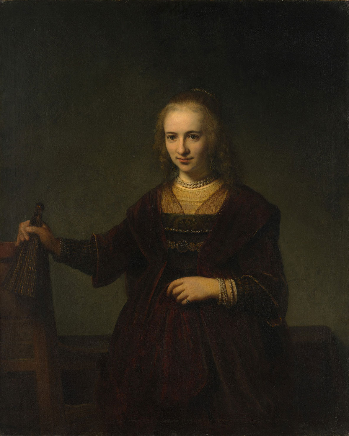Porträt einer Frau, gemalt von Rembrandt van Rijn, zeigt eine Frau in eleganter Kleidung, umgeben von warmen Brauntönen und goldenen Akzenten, mit starkem Licht-Schatten-Spiel, das ihre ruhige, aber ausdrucksstarke Haltung betont.