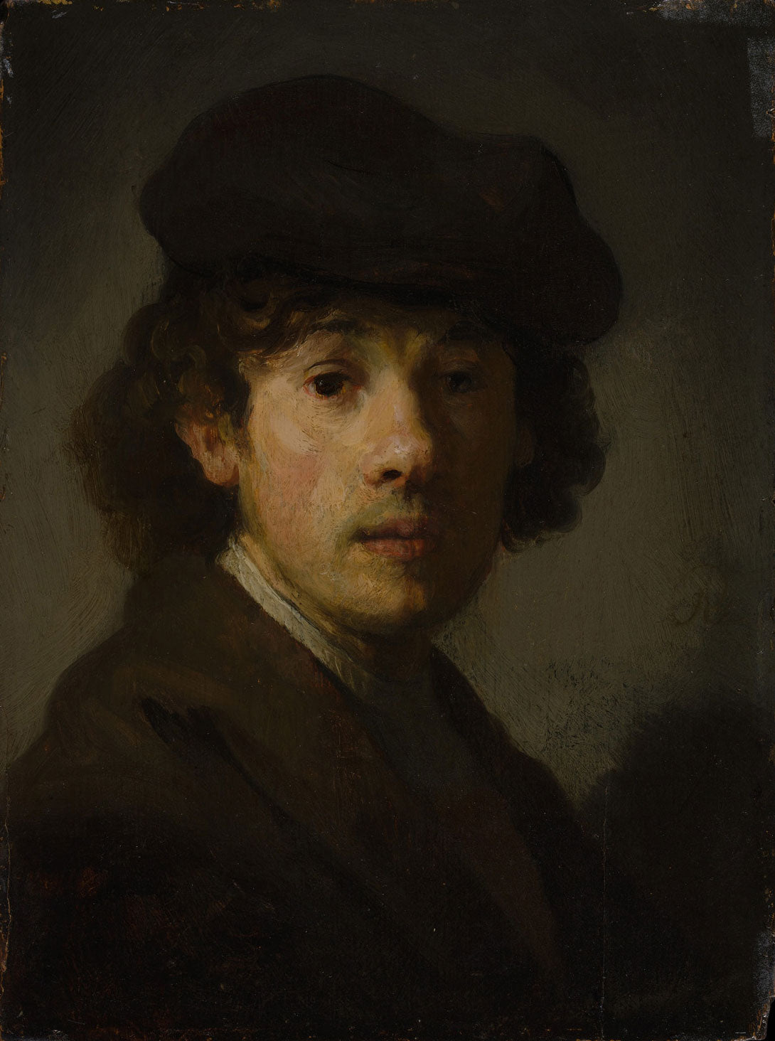 Selbstporträt von Rembrandt als junger Mann, gemalt 1629, zeigt den Künstler in einfachen, eleganten Kleidern mit warmen Brauntönen und meisterhaftem Licht-Schatten-Spiel.