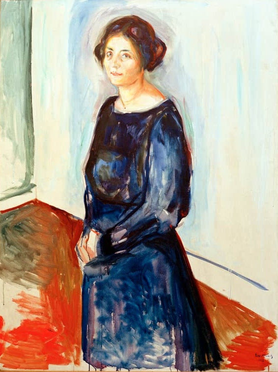Stehende Frau im blauen Kleid vor heller Wand mit roter Fläche – Edvard Munch Dame in Blau (Frau Dr. Barth) Kunstkopie