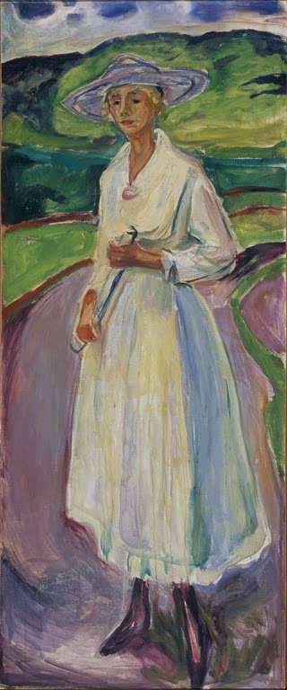 Frau mit breitkrempigem Hut in weißem Kleid steht vor grüner Landschaft – Edvard Munch Frau im weißen Kleid Kunstkopie