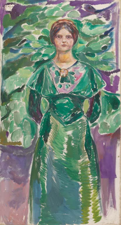 Frau im grünen Kleid steht vor grünem Laub und violettem Hintergrund – Edvard Munch Ingeborg in Grün Kunstkopie