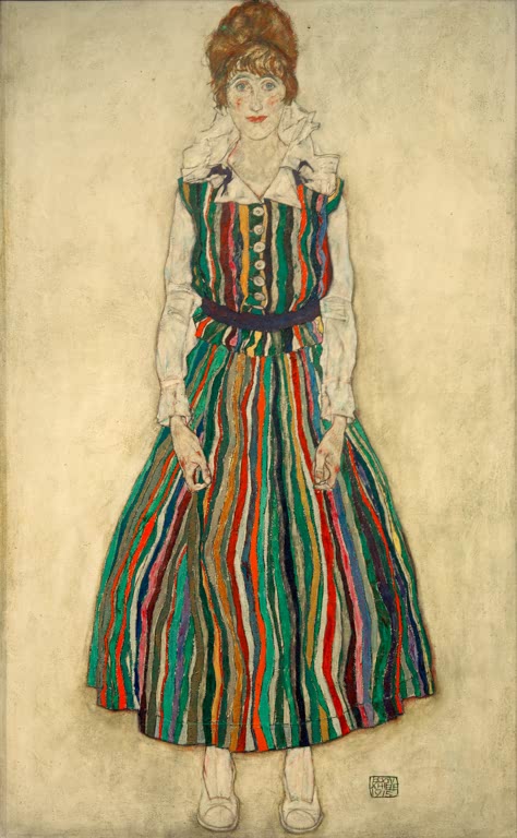 Frau im Kleid mit bunten Streifen, stehend, in voller Figur – Egon Schiele Bildnis der Frau des Künstlers, stehend Kunstkopie